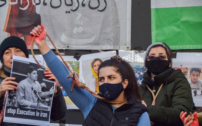 December 17, 2022, London, England, United Kingdom: A group of women staged a demonstration and performance in Piccadilly Circus in protest against the reported executions of anti-government protesters in Iran. The activists tied ropes around their necks and covered their hands in fake blood. London United Kingdom - ZUMAv130 20221217_zip_v130_012 Copyright: xVukxValcicx