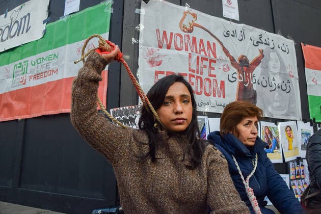 December 17, 2022, London, England, United Kingdom: A group of women staged a demonstration and performance in Piccadilly Circus in protest against the reported executions of anti-government protesters in Iran. The activists tied ropes around their necks and covered their hands in fake blood. London United Kingdom - ZUMAv130 20221217_zip_v130_004 Copyright: xVukxValcicx
