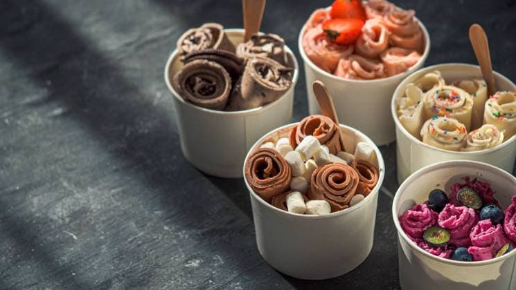 rolled ice creams in cone cups on dark background Rolled ice cream in cone cups on dark background. Different iced rolls or Thai style rolled ice cream with copy space for text or design. Banner. Natural hard daylight Copyright: xZoonar.com OlgaxSergeevax 16799195