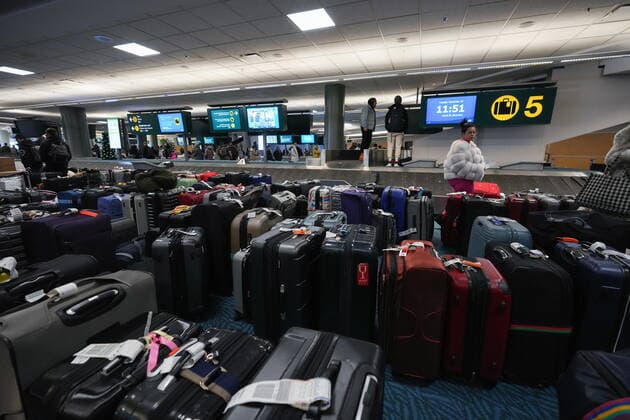 December 20, 2022, RICHMOND, BC, CANADA: A woman searches for her luggage at Vancouver International Airport after a snowstorm crippled operations leading to cancellations and major delays, in Richmond, B.C., on Tuesday, December 20, 2022. RICHMOND CANADA  - ZUMAc35_ 20221220_zaf_c35_069 Copyright: xDarrylxDyckx
