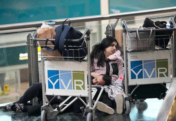 (221220) -- RICHMOND (CANADA), Dec. 20, 2022 -- People sleep on the floor at Vancouver International Airport in Richmond, British Columbia, Canada, on Dec. 20, 2022. Thousands of travelers were stuck at the Vancouver International Airport on Tuesday as many flights were cancelled or delayed due to the snowstorm. (Photo by Xinhua) CANADA-VANCOUVER INTERNATIONAL AIRPORT-SNOWSTORM-STRANDED PASSENGERS LiangxSen 