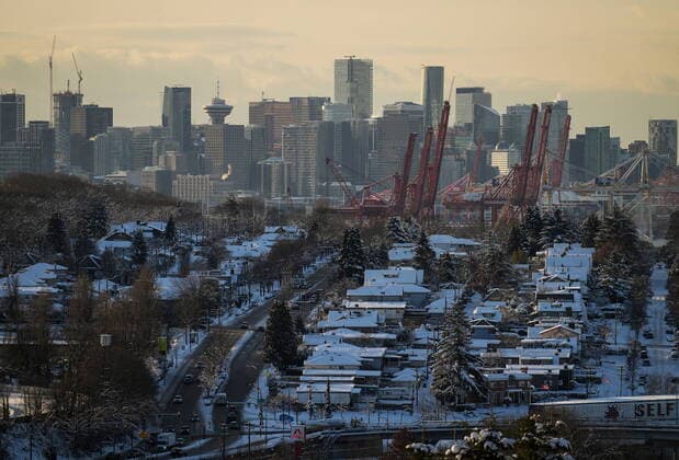 December 21, 2022, BURNABY, BC, CANADA: The roofs of houses are covered with snow as the downtown skyline is seen in the distance, in Vancouver, on Wednesday, December 21, 2022. A snowstorm dumped more than 30 centimetres of snow in Metro Vancouver this week. BURNABY CANADA  - ZUMAc35_ 20221221_zaf_c35_048 Copyright: xDarrylxDyckx