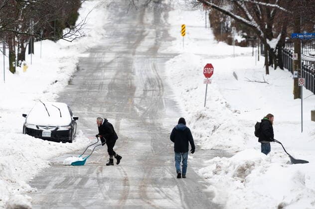 December 23, 2022, Ottawa, ON, Canada: People shovel snow in the Sandy Hill neighbourhood of Ottawa, on Friday, Dec. 23, 2022. Environment Canada has issued a winter storm warning for the region which is calling for flash freezing, icy and slippery surfaces, wind gusts and chills. Ottawa Canada  - ZUMAc35_ 20221223_zaf_c35_007 Copyright: xSpencerxColbyx