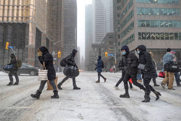 December 23, 2022, Toronto, Ontario, Canada: Pedestrians navigate icy conditions as they cross the street during a winter storm the has hit downtown Toronto with rain, ice, blowing snow, and intense wind as the region endures a day of extreme weather. Toronto Canada  - ZUMAnto 20221223_int_t155_001 Copyright: xWinstonxTangx