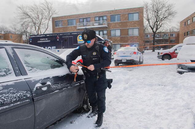 December 27, 2022, Montreal, PQ, Canada: A police officer attaches tape to a car outside an apartment building where two people were found dead in Montreal,Tuesday, December 27, 2022. Montreal police say a man and woman have died in the city s east end after what s believed to be a murder-suicide. Montreal Canada  - ZUMAc35_ 20221227_zaf_c35_003 Copyright: xGrahamxHughesx