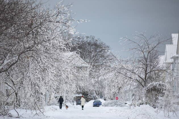 December 27, 2022, Fort Erie, ON, Canada: People walk along an ice covered street in Fort Erie, Ont., Tuesday, December 27, 2022, following a winter storm that swept through much of Ontario. Fort Erie Canada  - ZUMAc35_ 20221227_zaf_c35_044 Copyright: xNickxIwanyshynx
