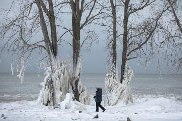 December 27, 2022, Fort Erie, Canada: A woman walks the shoreline of Lake Erie, near Fort Erie, Ont., Tuesday, following a winter storm that swept through much of Ontario. Fort Erie Canada  - ZUMAc35_ 20221227_zaf_c35_040 Copyright: xNickxIwanyshynx