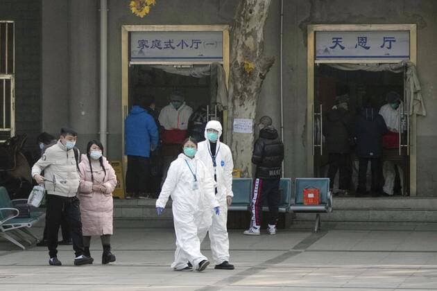 News Themen der Woche KW52 News Bilder des Tages Wuhan amid COVID surge Officials in protective gear walk in front of a funeral hall in Wuhan on Dec. 29, 2022, amid a surge in COVID-19 cases. The Chinese government eased its strict antivirus measures earlier in the month.  A14AA0001380154P