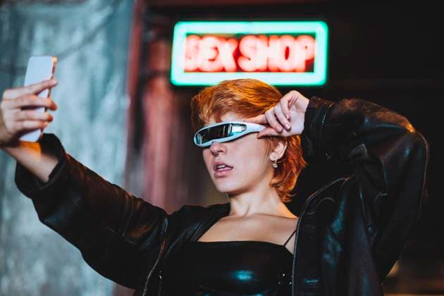 Young woman with smart glasses taking selfie through smart phone outside sex shop model released, Symbolfoto, IFRF01868