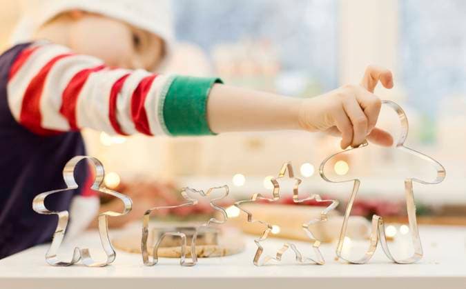 Hand of boy arranging cookie cutter on table model released, Symbolfoto property released, ONAF00303