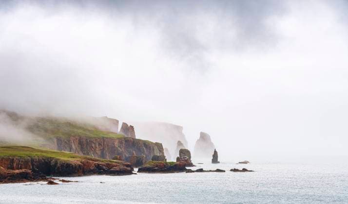 UK, Scotland, View of Drongs sea stacks during foggy weather, SMAF02457