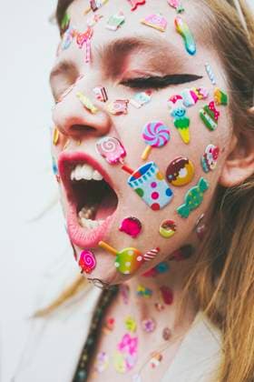 Creative Highlights Symbolbilder Woman with stickers on face screaming in front of white background model released, Symbolfoto, SVCF00255