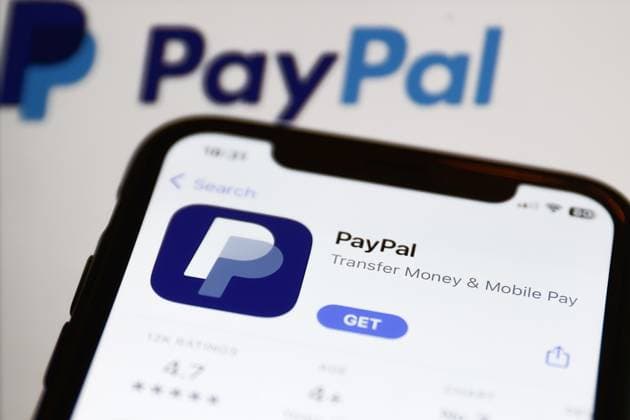 Payment Services Photo Illustrations PayPal on App Store displayed on a phone screen and PayPal logo displayed on a screen in the background are seen in this illustration photo taken in Krakow, Poland on January 2, 2023. Krakow Poland  Copyright: xJakubxPorzyckix originalFilename: porzycki-payments230102_npNKs.jpg