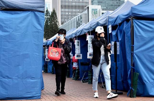 January 7, 2023, HONG KONG, CHINA: In Hong Kong, woman put back facemask as she leave the Covid Testing Station in the city centre after completed bio-sampling for Covid-19 Tests. It is required for all Hong Kong citizens and foreigners to obtain Covid-19 Nucleic Acid Testing Negative Certificate 48 hours prior to the departure for China Mainland. Hong Kong-China boarder will be reopened tomorrow on 8th of January after 3 years of closure.Jan-7,2023Hong Kong.ZUMA HONG KONG CHINA - ZUMAl137 20230107_zap_l137_006 Copyright: xLiauxChung-renx