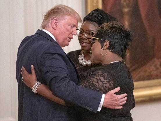 **FILE PHOTO** Diamond of Pro Trump duo Diamond and Silk Has Passed Away at 51. United States President Donald J. Trump hugs Diamond and Silk as he mentions them during his remarks at the Presidential Social Media Summit in the East Room of the White House in Washington, DC on Thursday, July 11, 2019. Copyright: x 2019xRonxSachsxConsolidatedxNewsxPhotosxxxAllxRightsxReservedx