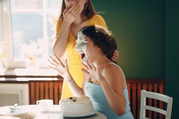 Young woman dips face in white cake with cream. Happy birthday concept. Young woman dips face in white cake with cream. Happy birthday concept Copyright: xZoonar.com Maxx 17004661 ,model released, Symbolfoto ,property released