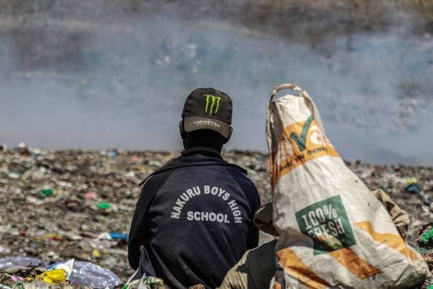 January 13, 2023, Nakuru, Kenya: A waste picker ponders as he rests looking towards burning garbage at Nakuru main dumping yard. Since waste is rarely segregated and is heavily mixed with all sorts of trash, burning it can produce potentially toxic fumes that can be a public health problem and can also contribute to climate change. Communities working and living near dumping sites where garbage is openly burned are at risk of contracting respiratory diseases and cancers. Women exposed to those fumes may suffer from reproductive health problems. Nakuru Kenya - ZUMAs197 20230113_zaa_s197_377 Copyright: xJamesxWakibiax