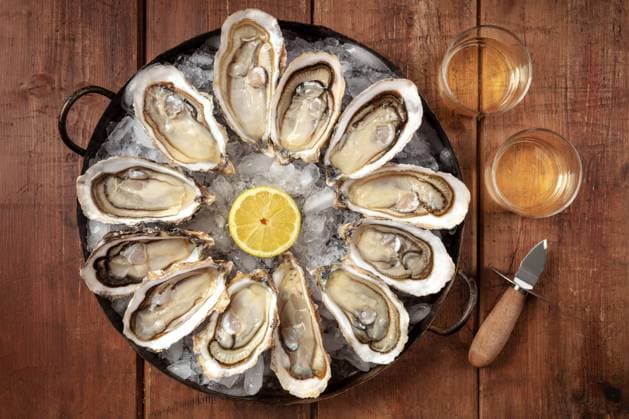 Oysters with wine, lemon, and a shucking knife Oysters with wine, lemon, and a shucking knife, overhead flat lay shot on a rustic background Copyright: xZoonar.com KaterinaxSolovyevax 16847979