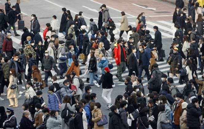 Tokyo scene amid coronavirus pandemic People wear face masks outdoors near Tokyo s Shibuya station on Jan. 20, 2023. Japanese Prime Minister Fumio Kishida announced same day plans to downgrade the legal status of COVID-19 to the equivalent of seasonal influenza in the spring.  A14AA0001386701P