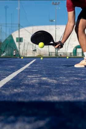 Hand of young man with racket playing paddle tennis at sports court model released, Symbolfoto property released, FMOF01613