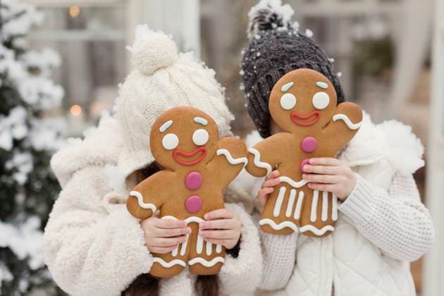 Sister and brother covering face with gingerbread man cookies model released, Symbolfoto property released, ONAF00374