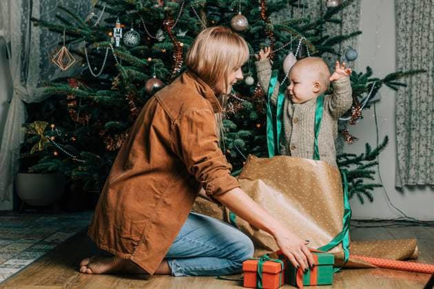 Happy mother with son playing by Christmas tree at home model released, Symbolfoto property released, VSNF00249