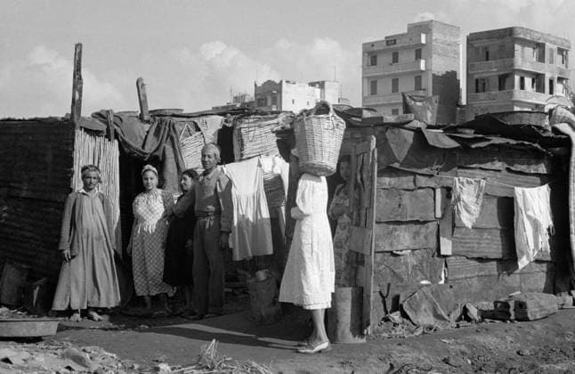 Port Said, Egypt. December 19, 1956. Local people stand near the temporary housing in the Al-Manakh quarter destroyed by the British and French forces during the Suez Crisis. Pyotr Yegorov TASS  13774591