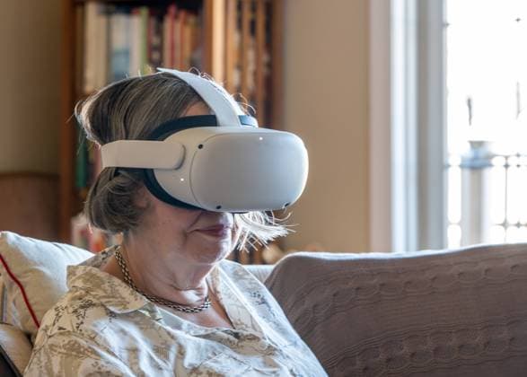 RECORD DATE NOT STATED Senior lady seated at home and watching a movie or a quest app on a modern virtual reality VR headset, model released, , 39408874.jpg, virtual reality, vr, vr headset, quest, senior adult, metaverse, senior, lady, seated, home, 128gb, House, controller, device, digital, display, elderly, electronic, entertainment, equipment, experience, futuristic, game, gaming, gear, glasses, goggles, head set, headset, internet, mask, modern, multiverse, new, product, reality, redesigned, room, sensory, sitting, smile, technology, virtual, wearable, wifi, wireless, woman, women