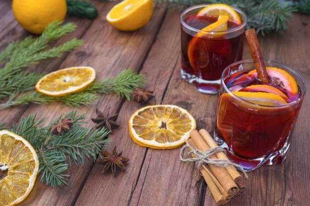 RECORD DATE NOT STATED Mulled wine and spices on a wooden background with branches of a Christmas tree. Selective focus. , 41051558.jpg, christmas, newyear, wine, cinnamon, drink, anise, glass, spice, cup, holiday, red, fruit, hot, sweet, warm, wooden, traditional, decoration, food, alcohol, clove, mulled, homemade, delicious, winter, orange, star, beverage, punch, aromatic, flavor, aroma, seasonal, spruce, advent, lighting, season, slice, grog, xmas, heat, lemon, mug, mulled wine, nobody, bright, wood, selective focus, stick, vertical