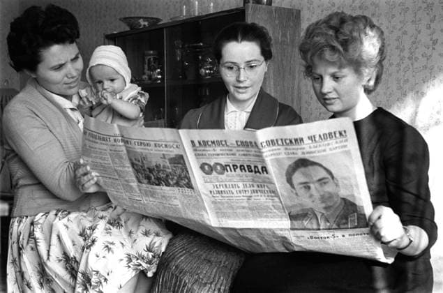 Moscow. USSR. June 15, 1963. Spouses of Soviet cosmonauts Marina Popovich, Valentina Gagarina, Valentina Bykovskaya (L-R) read an article about a group space flight of V.Bykovsky and V.Tereshkova in Pravda newspaper. Marina Popovich holds Valery, a son of Valery Bykovsky and Valentina Bykovskaya. Valentin Cheredintsev TASS  277050