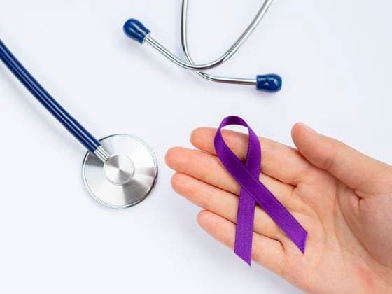 close up hand holding purple ribbon with stethoscope OLYMPUS DIGITAL CAMERA Copyright: xZoonar.com InaPlavansx 18568152 ,model released, Symbolfoto ,property released