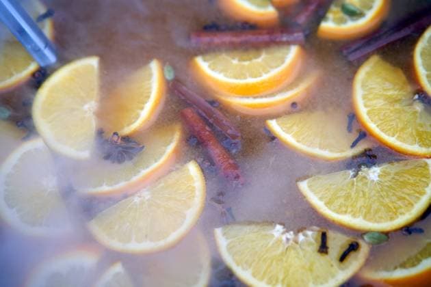 RECORD DATE NOT STATED closeup of mulled wine citrus fruit, preparing in big old metal kettle on fire, above view, Traditional Christmas fair market beverage , 35320654.jpg, mood, wine, warm, punch, relax, smoke, apple, prepare, seasonal, boiler, heat, steam, seasoning, xmas, adding, citron, condiment, festive, piece, christmas, drink, alcohol, holiday, hot, orange, spice, pot, pan, cinnamon, slice, making, red, anise, aromatic, cosiness, grog, metal, beverage, fruit, traditional, winter, cooking, mulled, citrus