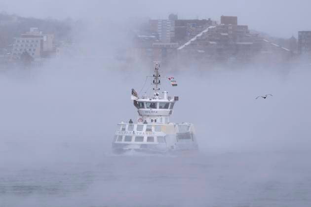 February 4, 2023, Halifax, NS, Canada: Passengers stand on the open deck while riding a ferry across Halifax Harbour as sea smoke, or ice fog, forms in Halifax on Saturday, February 4, 2023. Environment Canada has warned of windchill values between -30 C and -40 C across the Maritimes as an Arctic air mass moves across the region. Halifax Canada  - ZUMAc35_ 20230204_zaf_c35_008 Copyright: xDarrenxCalabresex