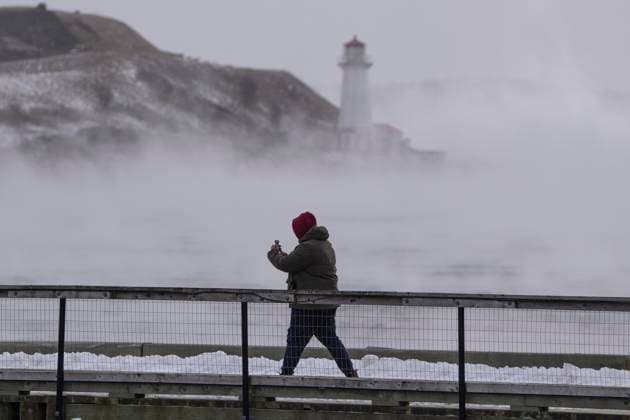 February 4, 2023, Halifax, NS, Canada: A man walks on the waterfront as sea smoke, or ice fog, forms in Halifax Harbour on Saturday, February 4, 2023. Environment Canada has warned of windchill values between -30 C and -40 C across the Maritimes as an Arctic air mass moves across the region. Halifax Canada  - ZUMAc35_ 20230204_zaf_c35_009 Copyright: xDarrenxCalabresex