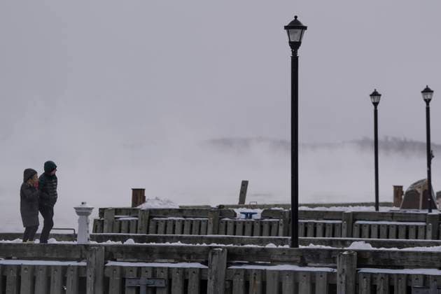 February 4, 2023, Halifax, NS, Canada: A couple walks on the waterfront as sea smoke, or ice fog, forms in Halifax Harbour on Saturday, February 4, 2023. Environment Canada has warned of windchill values between -30 C and -40 C across the Maritimes as an Arctic air mass moves across the region. Halifax Canada  - ZUMAc35_ 20230204_zaf_c35_010 Copyright: xDarrenxCalabresex