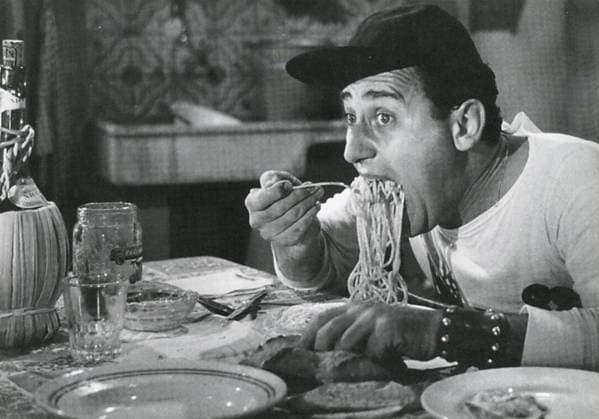 Italian actor Alberto Sordi eating spaghetti with a cap, scene from the movie An American in Rome, Italy 1954 