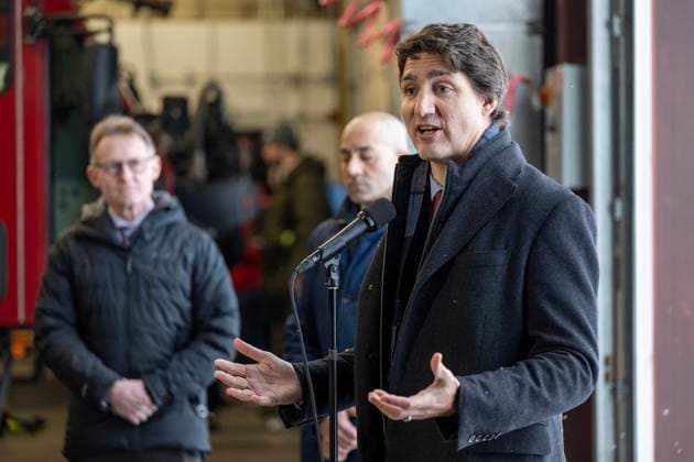 February 13, 2023, Whitehorse, YUKON, CANADA: Prime Minister Justin Trudeau speaks at Erik Nielsen International Airport during a press conference while Yukon MP Brendan Hanley, left, and Yukon Premier Ranj Pillai look on in Whitehorse, Yukon, on February 13, 2023. Whitehorse CANADA  - ZUMAc35_ 20230213_zaf_c35_077 Copyright: xMikexThomasx
