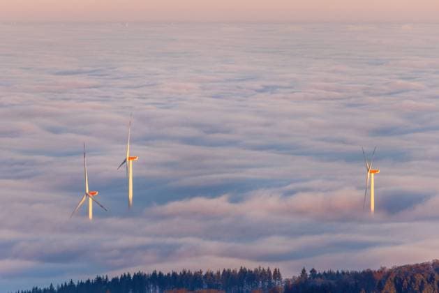 Windräder im Nebel Windräder ragen kurz nach Sonnenaufgang vom Großen Feldberg aus gesehen aus einer Nebeldecke., Schmitten Hessen Deutschland *** Wind turbines in the fog Wind turbines rise from a fog cover seen from the Großer Feldberg shortly after sunrise , Schmitten Hessen Germany