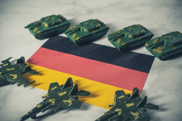 4 February 2023: Germany flag surrounded by toy tanks and fighter jets, symbol image armament of Bundeswehr in Germany *** Deutschland Flagge umgeben von Spielzeug Panzer und Kampfjets, Symbolbild Rüstung der Bundeswehr in Deutschland