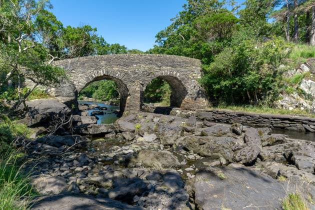 view of the historic Old Weir Bridge at The Meeting of The Waters in Killarney National Park A view of the historic Old Weir Bridge at The Meeting of The Waters in Killarney National Park Copyright: xZoonar.com NandoxLardix 19166617