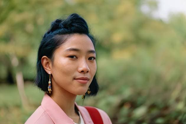 Generative AI illustration of content ethnic female looking at camera on blurred backdrop of summer nature on sunny day AdalbertoRodriguez_ID12762_387158_002 Copyright: xAdalbertoxRodriguezx Model Released