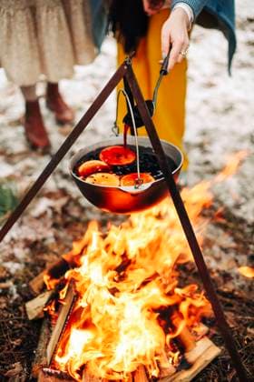 Pot with mulled wine over fire From above traditional mulled wine with slices of orange preparing in pot over burning logs in winter in countryside Copyright: xZoonar.com DashaxPetrenkox 17561199