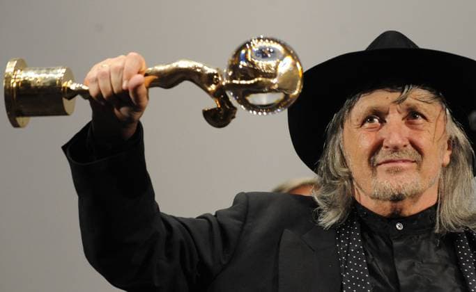 FILE - In the file photo, Slovakian director Juraj Jakubisko shows a Crystal Globe for his long-term contribution to world cinematography he received prior the world premiere of his historical thriller Bathory during the 43rd International Film Festival in Karlovy Vary, Czech Republic, on July 5, 2008. One of the leading film-makers of the Czechoslovak New Film Wave of the 1960s, died in Prague, where he lived, on Friday, Feb. 24, 2023. He was 84. (CTKxPhoto RenexVolfik) CTKPhotoP200807050274701  CTKPhotoP200807050274701