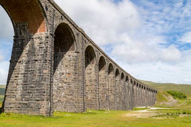 Looking up at the Ribblehead Viaduct under a bright sky pictured in the Yorkshire Dales. Copyright: xLoopxImages JasonxWellsx JWS00623WT114