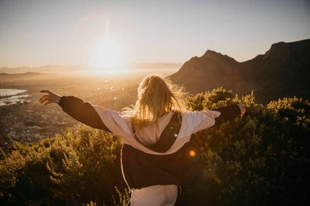 Woman with arms outstretched at sunrise model released, Symbolfoto, LHPF01506