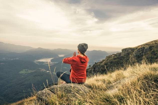 Mature woman meditating with hands clasped on mountain model released, Symbolfoto, UUF28225