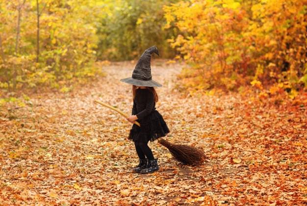Cute happy little redhaired girl dressed in witch costume sitting on broom over autumn forest background with copy space Cute happy little redhaired girl dressed in witch costume sitting on broom over autumn forest background with copy space, holding her hat with hands. Holiday of halloween celebration concept Copyright: xZoonar.com DashaxPetrenkox 17546381 ,model released, Symbolfoto ,property released