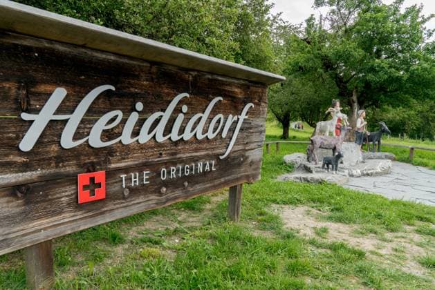 Maienfeld, GR Switzerland - 9 June 2019: tourist attraction sign and wooden puppets of the fiction Maienfeld, GR Switzerland - 9 June 2019: tourist attraction sign and wooden puppets of the fictional Heidi story in the Swiss Alps village of Maienfeld Copyright: xZoonar.com NandoxLardix 13965350
