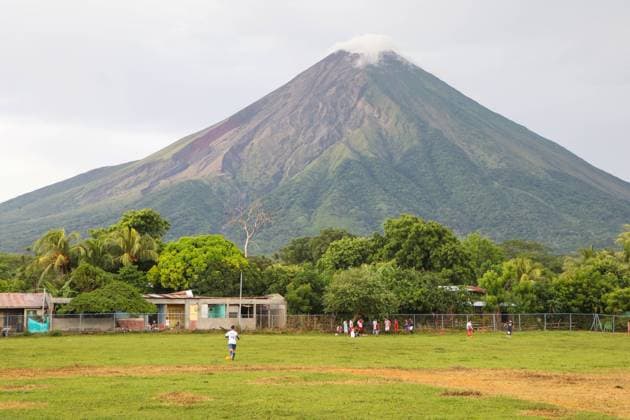 People playing soccer game at the foot of the volcano, Ometepe island, Nicaragua Nicaragua Copyright: xElisaxNavarrox xVWPicsx ENS-NICARAGUA-33