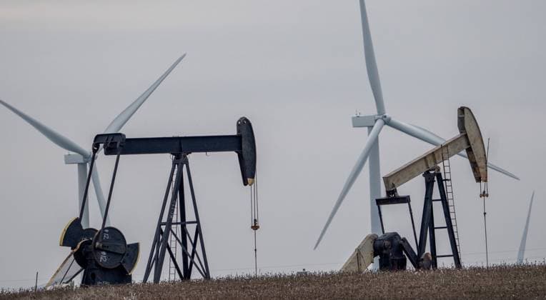 Oil derricks and wind mills are juxtaposed northwest of Dallas in western Texas on Wednesday, March 8, 2023. Texas was built on oil but now the state is a national leader in wind and solar energy.  DAL20230308104 PatxBenic
